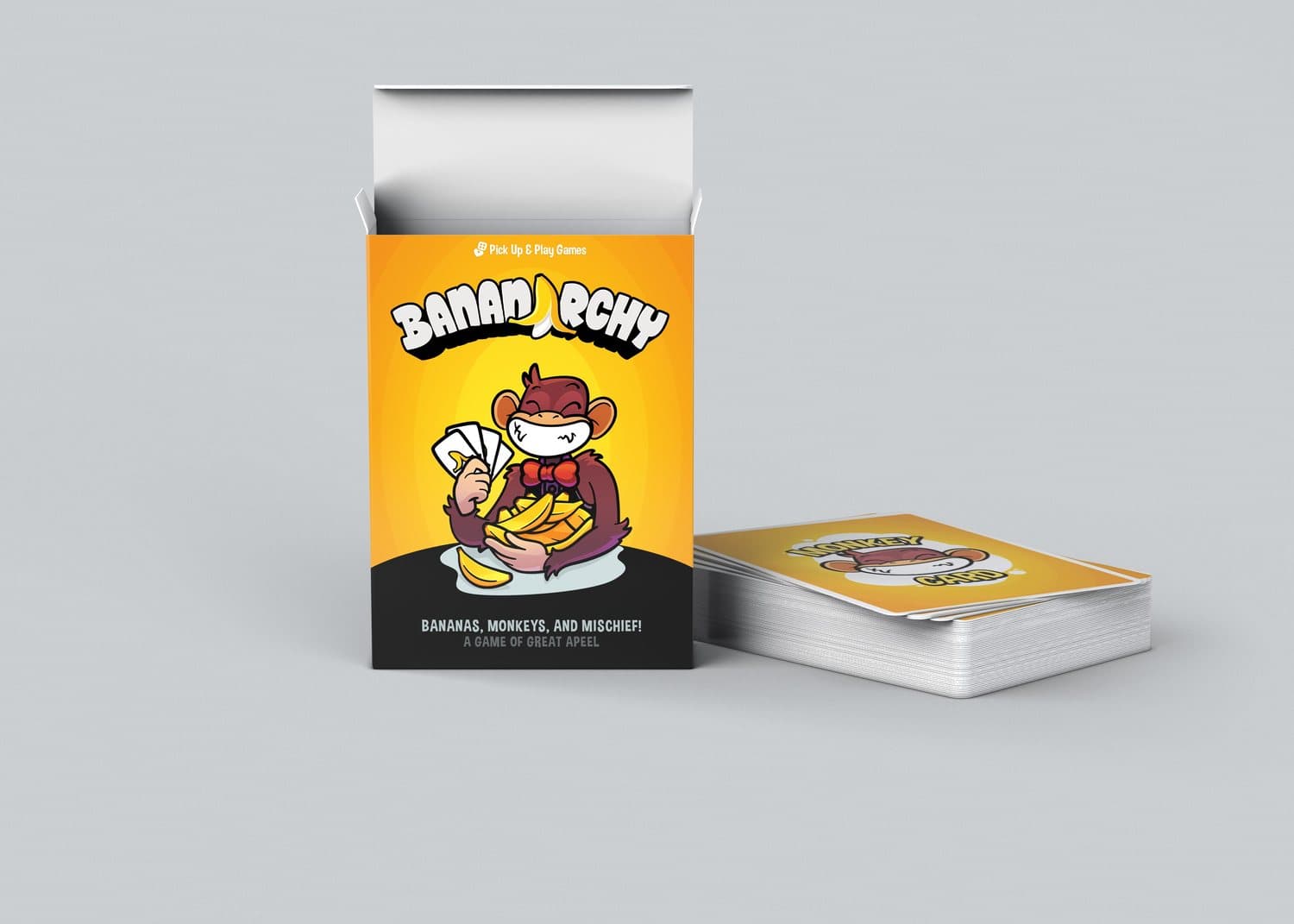 The open Bananarchy box standing next to a stacked deck of Monkey Cards